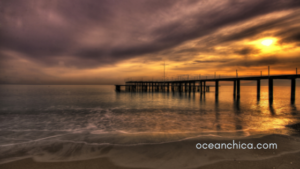 sunset over ocean with pier